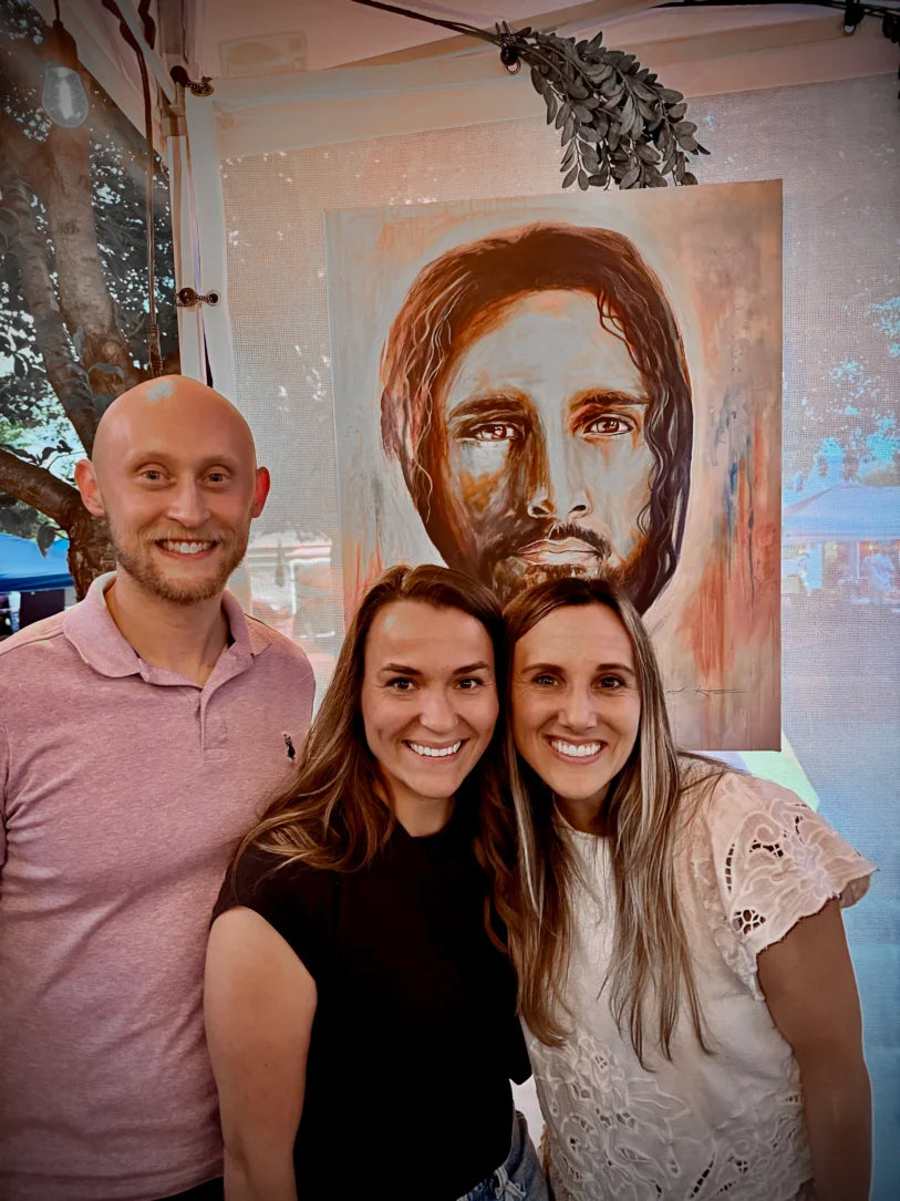 Three people standing in from of Christian Artwork with excitement and big smiles after purchasing Artwork by Kamrah Holt Fine Art.