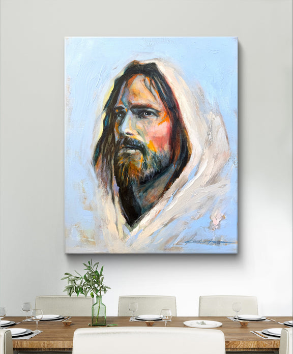 Jesus painting depicting Jesus in a colorful and loving way with a vibrant blue background over a dinning table. 
