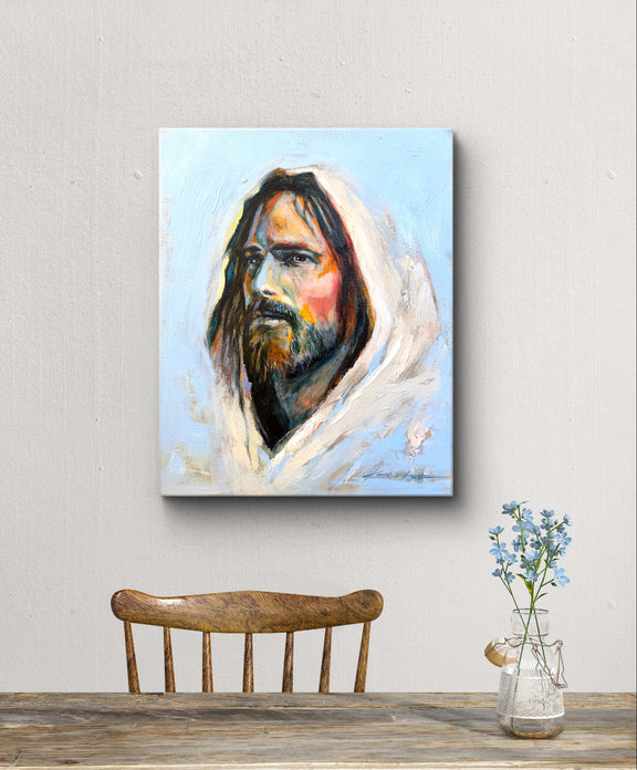Minimalist dining table with a painting of Jesus hung on the wall, depicting jesus with vibrant color representing diversity and love. Titled :The color of Grace. 