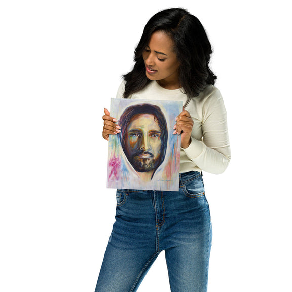 8" x 10" oil painting print of Jesus being held in the hand of a woman displaying the artwork. 
