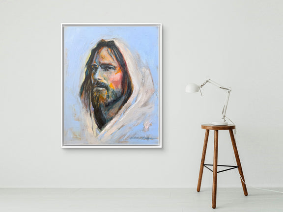White Framed Original Oil Painting, a portrait of Jesus in periwinkle blue with big brushstrokes and thick paint, a lot of texture and vibrant colors with a lamp that is sitting on a stool. 
